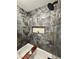 Modern bathroom featuring dark marble tile surrounding the soaking tub and shower niche at 308 Cannes St, Henderson, NV 89015
