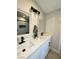 Elegant bathroom with double sink vanity, featuring modern fixtures and a glimpse of the shower at 308 Cannes St, Henderson, NV 89015