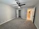 Spacious bedroom featuring neutral tones, ceiling fan, and connecting doors to a closet and bathroom at 308 Cannes St, Henderson, NV 89015