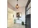 Entryway features stylish chandelier, a glass console table with decor, and art at 308 Cannes St, Henderson, NV 89015