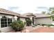 View of the front exterior showcasing its neutral paint, tile roof and beautiful desert landscaping at 308 Cannes St, Henderson, NV 89015