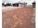 Wide shot of front yard with desert landscaping, and a front gate leading to the three-car garage at 308 Cannes St, Henderson, NV 89015