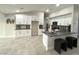 Modern kitchen features sleek white cabinetry, gray countertops, island with seating, and stainless steel appliances at 308 Cannes St, Henderson, NV 89015