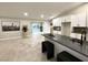 Open concept kitchen and living area with gray countertops and access to the backyard pool at 308 Cannes St, Henderson, NV 89015