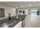 Modern kitchen featuring gray countertop island, sink, and stainless steel dishwasher at 308 Cannes St, Henderson, NV 89015