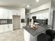 Modern kitchen with stainless steel appliances, white cabinets, and a gray countertop island at 308 Cannes St, Henderson, NV 89015