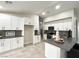 Contemporary kitchen with white cabinets, gray countertop island, and stainless steel appliances at 308 Cannes St, Henderson, NV 89015
