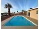 Backyard swimming pool with an adjacent palm tree, desert landscaping, and a patio at 308 Cannes St, Henderson, NV 89015