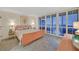 Bright bedroom has modern shutters, and a view of the city at 3111 Bel Air Dr # 7D, Las Vegas, NV 89109