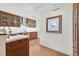 Contemporary kitchen features hardwood floors, custom wood cabinets, island sink, modern appliances and stylish lighting at 3111 Bel Air Dr # 7D, Las Vegas, NV 89109