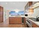 Contemporary kitchen with an island sink, modern appliances, wood cabinets, hardwood floors, and a large window at 3111 Bel Air Dr # 7D, Las Vegas, NV 89109