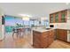 Bright kitchen with wood cabinets, stainless appliances, island sink, and large window overlooking a beautiful view at 3111 Bel Air Dr # 7D, Las Vegas, NV 89109