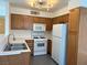 Kitchen with white appliances and wood cabinets at 3119 Key Largo Dr # 204, Las Vegas, NV 89120