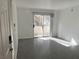Bright living room featuring a sliding glass door to the outside and gray tile floors at 3119 Key Largo Dr # 204, Las Vegas, NV 89120