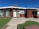 Exterior shot of a single-story brown home featuring a concrete porch and artificial turf landscaping at 3521 Chevy Chase Ave, Las Vegas, NV 89110