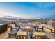 Beautiful rooftop patio boasts comfortable seating around a cozy fire pit with scenic mountain views at 38 Promenade Isle Ln, Henderson, NV 89011