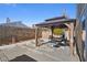 Backyard features a gazebo with a dining set, concrete pavers, and a block wall for privacy at 4136 Broadriver Dr, Las Vegas, NV 89108