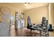 Bedroom with a vanity, large mirror, black gaming chair, and wooden floors at 4136 Broadriver Dr, Las Vegas, NV 89108