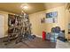 Home gym equipped with weightlifting equipment, storage, and a laminated wood floor at 4136 Broadriver Dr, Las Vegas, NV 89108