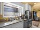 Well-lit kitchen featuring a stainless steel refrigerator and a large window over the sink at 4136 Broadriver Dr, Las Vegas, NV 89108