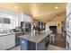 Modern kitchen flowing into living room with granite countertops and stainless steel appliances at 4136 Broadriver Dr, Las Vegas, NV 89108