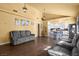 A cozy living room flowing to kitchen with hardwood floors and contemporary furnishings at 4136 Broadriver Dr, Las Vegas, NV 89108