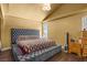 Main bedroom with a king bed, dark floors, and natural light from a window at 4136 Broadriver Dr, Las Vegas, NV 89108