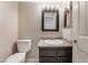 Bathroom featuring granite countertop, dark cabinets, white tile and new toilet at 4853 Rollingwood Cir, Las Vegas, NV 89121