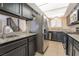 Kitchen featuring stainless steel refrigerator, granite countertops, dark cabinets and tile flooring at 4853 Rollingwood Cir, Las Vegas, NV 89121