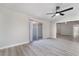 Bright living room features a sliding glass door, modern ceiling fan and light wood flooring at 5119 Vista Del Rancho Way, North Las Vegas, NV 89031