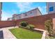 Charming backyard featuring brick, artificial grass, small plants, and shaded seating at 7029 Parrot Bay Way, Las Vegas, NV 89118