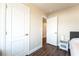 This bedroom features wood-look floors, neutral paint, and a view into the hall and out to the bedrooms at 7029 Parrot Bay Way, Las Vegas, NV 89118