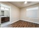 Bright bedroom with hardwood floors, a window, and an ensuite bathroom at 7029 Parrot Bay Way, Las Vegas, NV 89118