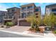 Charming three-story home features a balcony, tile roof, and brick driveway at 7029 Parrot Bay Way, Las Vegas, NV 89118