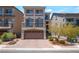 Charming three-story home features a balcony, tile roof, and brick driveway at 7029 Parrot Bay Way, Las Vegas, NV 89118