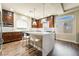 Modern kitchen with stainless steel appliances, a center island with a marble countertop and a window at 7029 Parrot Bay Way, Las Vegas, NV 89118
