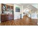 Inviting living area with hardwood floors and custom bar perfect for entertaining at 7029 Parrot Bay Way, Las Vegas, NV 89118