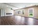 Spacious living room with modern fireplace, wood floors, ceiling fan and recessed lighting at 7029 Parrot Bay Way, Las Vegas, NV 89118