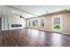 Spacious living room with modern fireplace, wood floors, ceiling fan and recessed lighting at 7029 Parrot Bay Way, Las Vegas, NV 89118