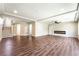Spacious living room with modern fireplace, wood floors, ceiling fan and recessed lighting at 7029 Parrot Bay Way, Las Vegas, NV 89118