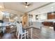 Spacious living room and kitchen area with hardwood floors, a desk, and island with marble countertop at 7029 Parrot Bay Way, Las Vegas, NV 89118
