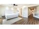 Bright main bedroom features a ceiling fan, wood floors, a modern headboard, and ensuite bath at 7029 Parrot Bay Way, Las Vegas, NV 89118