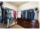 A well-organized walk-in closet with wood floors offers plenty of room to hang and fold clothing at 7029 Parrot Bay Way, Las Vegas, NV 89118