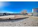 Large backyard with covered patio, and red gravel at 7477 Ullom Dr, Las Vegas, NV 89139