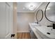 Modern bathroom featuring dual sinks, gray vanity, wood-look flooring, and stylish fixtures at 7477 Ullom Dr, Las Vegas, NV 89139