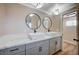 Stylish bathroom with dual sinks, marble countertops, modern fixtures, and updated lighting at 7477 Ullom Dr, Las Vegas, NV 89139