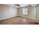 Bedroom featuring wood floors, neutral walls, and a ceiling fan at 7477 Ullom Dr, Las Vegas, NV 89139