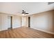A bright and spacious bedroom with wood-look flooring and closet with doors at 7477 Ullom Dr, Las Vegas, NV 89139