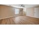 Spacious bedroom featuring light beige walls, wood-look flooring, and bright natural light from the window at 7477 Ullom Dr, Las Vegas, NV 89139