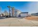 Two-story home featuring a grand entrance and a large, open driveway at 7477 Ullom Dr, Las Vegas, NV 89139